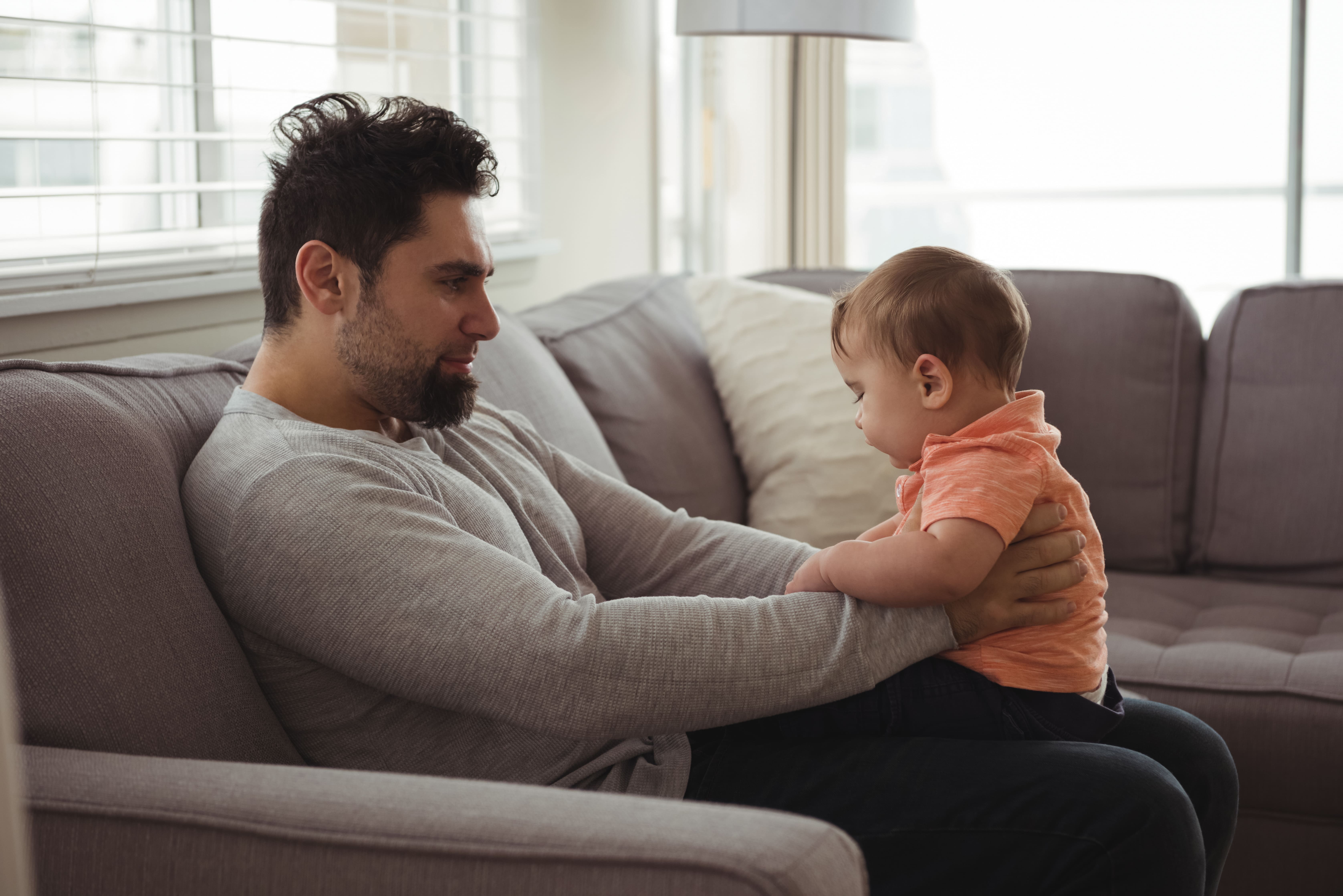 father-playing-with-his-baby-sofa-living-room (1).jpg